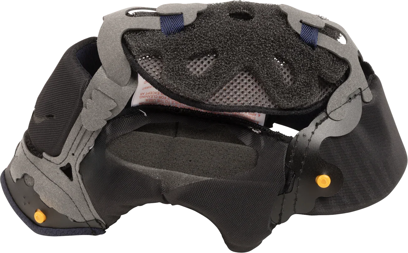 Motorcycle helmet interior with black foam padding, gray shell, and yellow adjustment knobs for comfort and fit