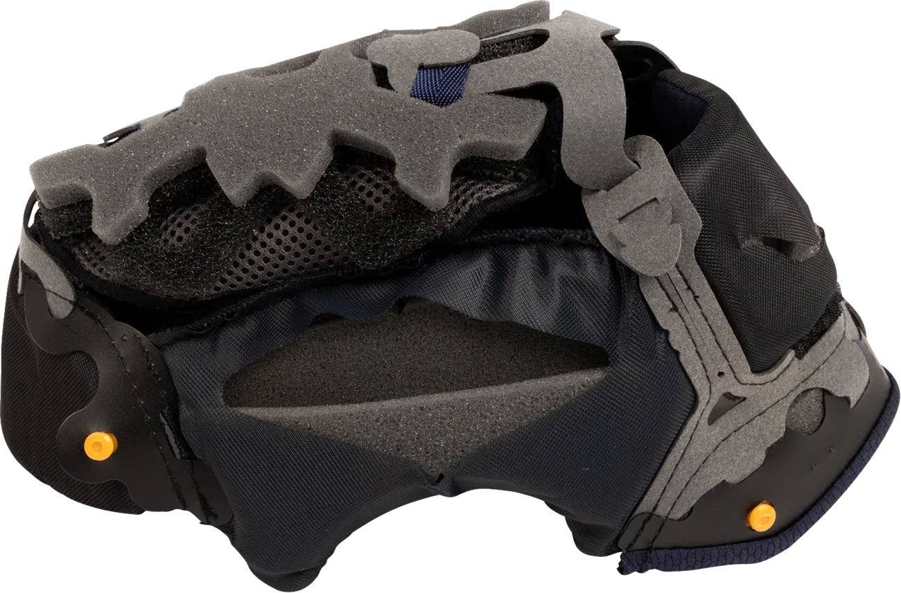 Motorcycle helmet interior with gray foam padding, black mesh lining, and orange adjustment pins for comfort and fit.