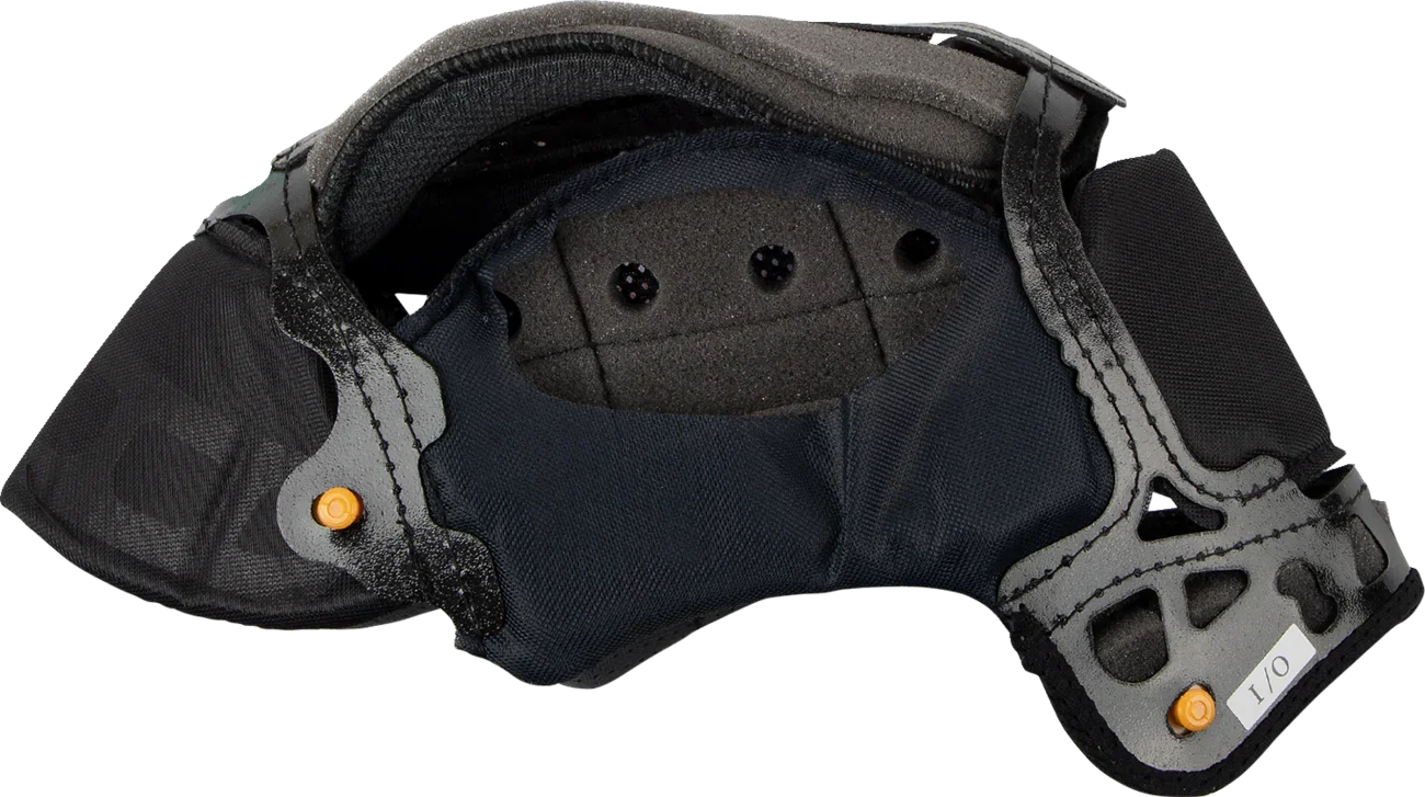 Black motorcycle helmet interior with padded lining, ventilation holes, and orange adjustment dials