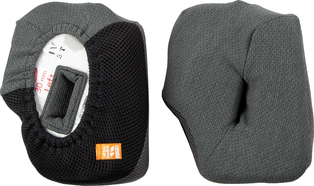 Gray and black motorcycle helmet cheek pads with mesh lining and emergency pull tab