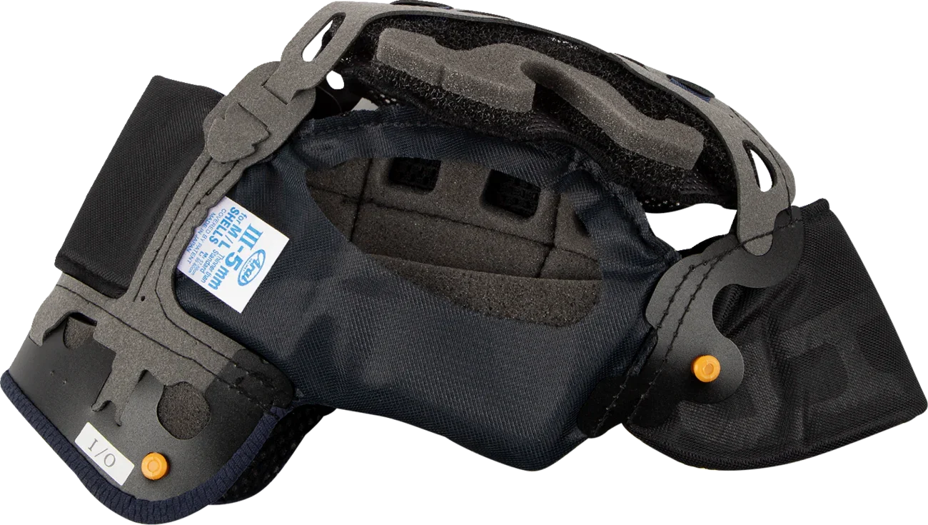 Motorcycle helmet interior with foam padding, chin strap, and size label for comfort and safety