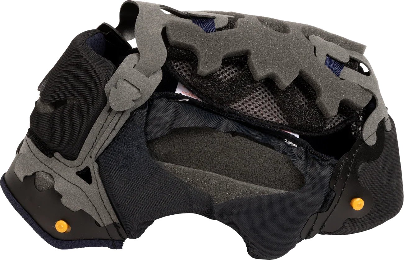 Motorcycle helmet interior with gray foam padding, black mesh lining, and orange adjustment pins for comfort and fit.