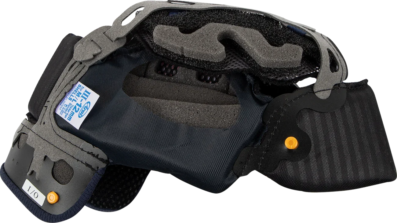 Black motorcycle helmet interior with gray foam padding, orange adjustment knobs, and size label