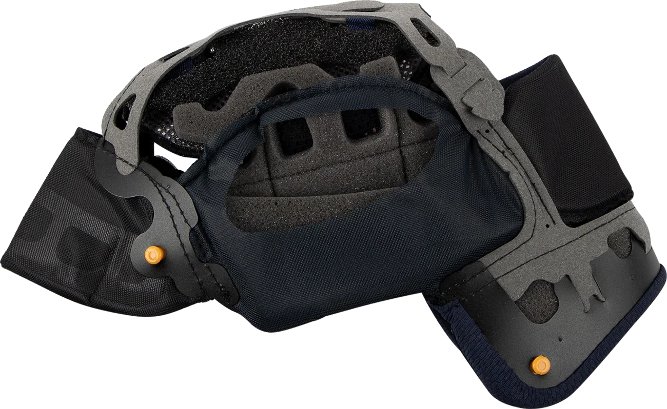Motorcycle helmet interior with black padding, gray shell, and orange adjustment dials for comfort and fit